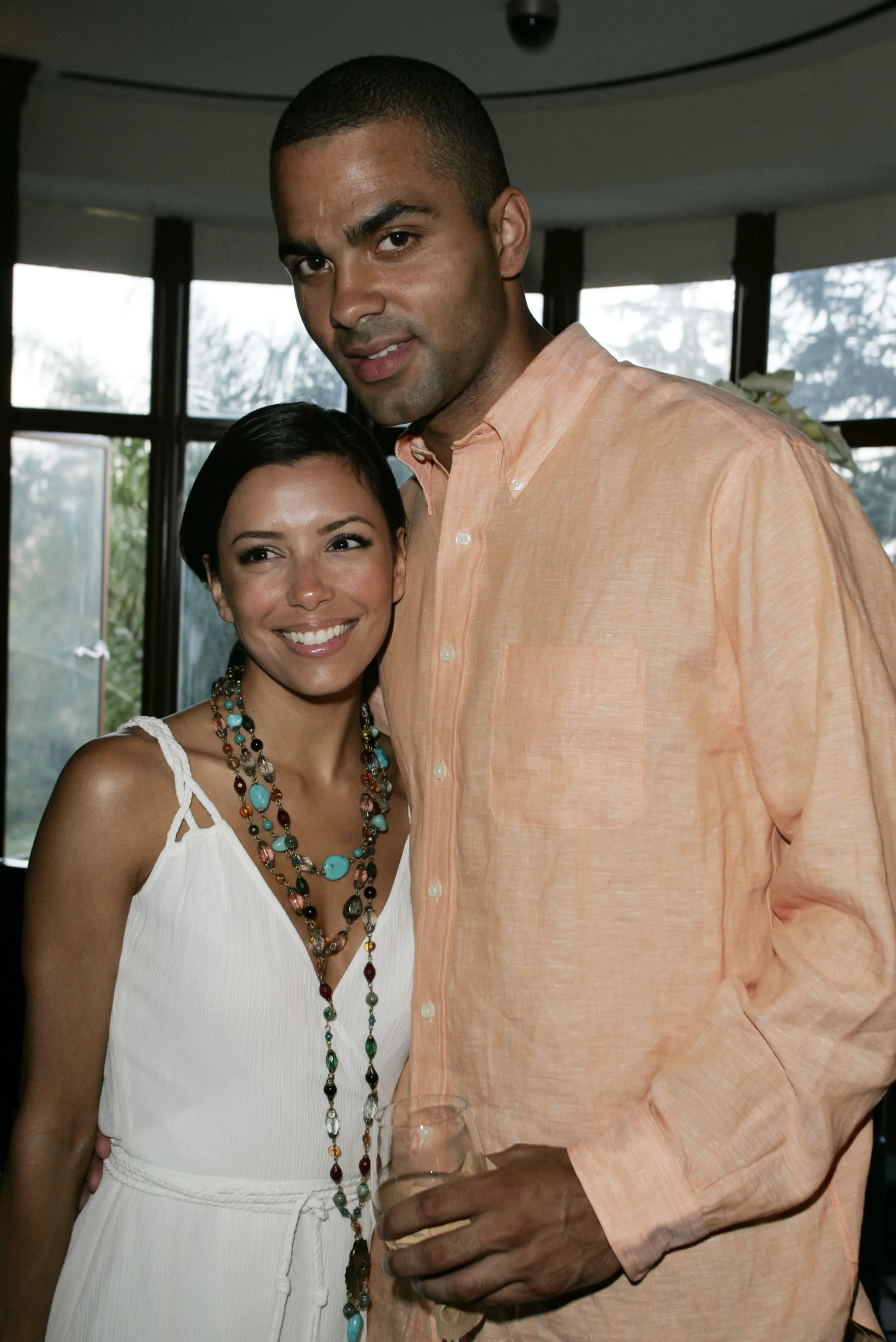 Eva Longoria and Tony Parker smiling at an event.