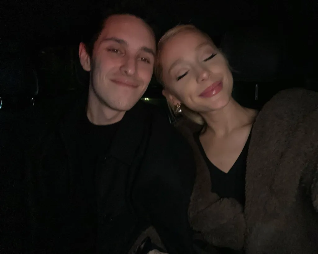 Ariana Grande and Dalton Gomez posing for a selfie in the dark.