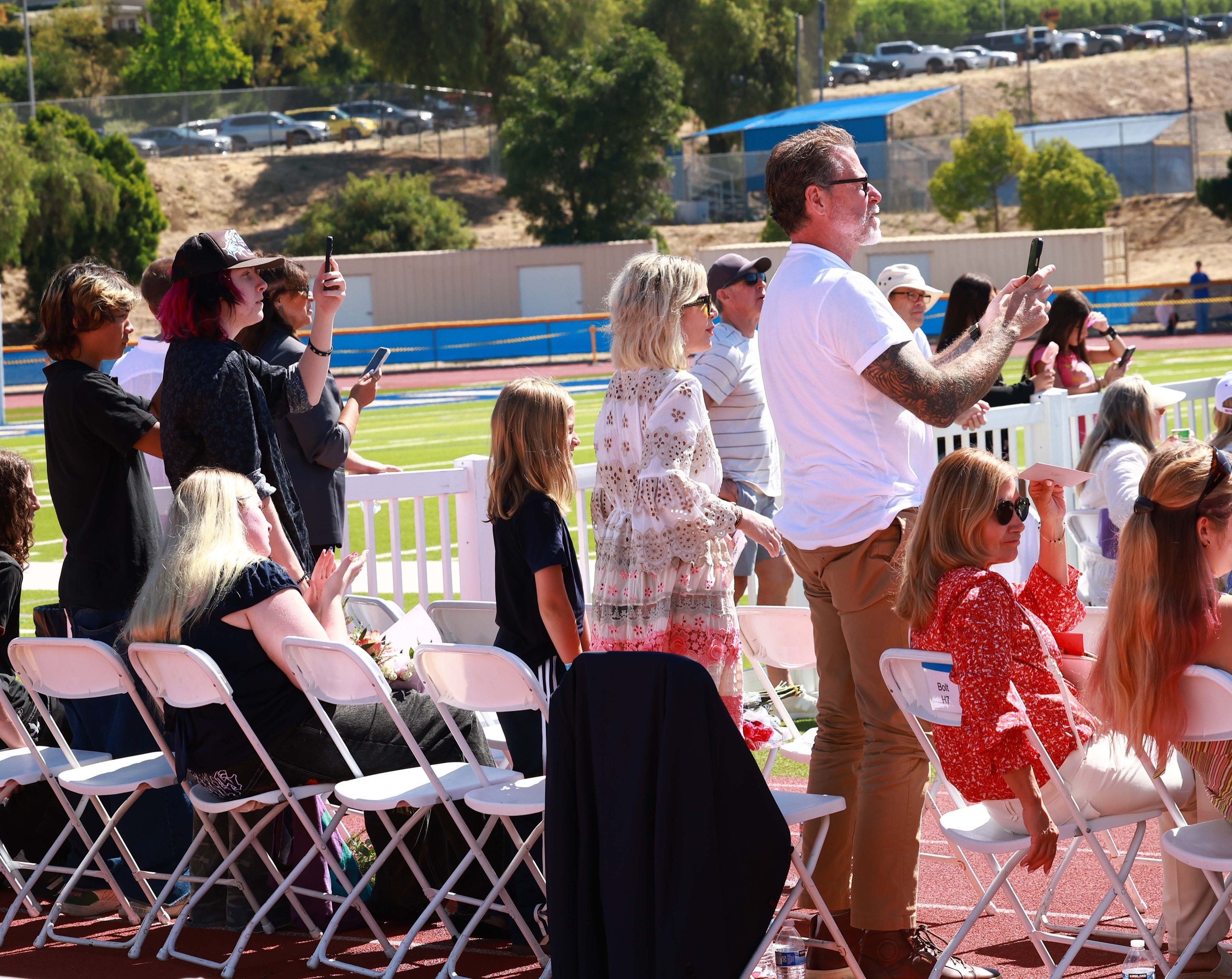 Tori Spelling and Dean McDermott attend their daughter's graduation.