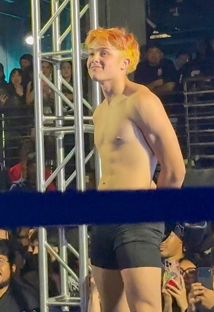 Knox Jolie-Pitt in a boxing ring during an exhibition fight.