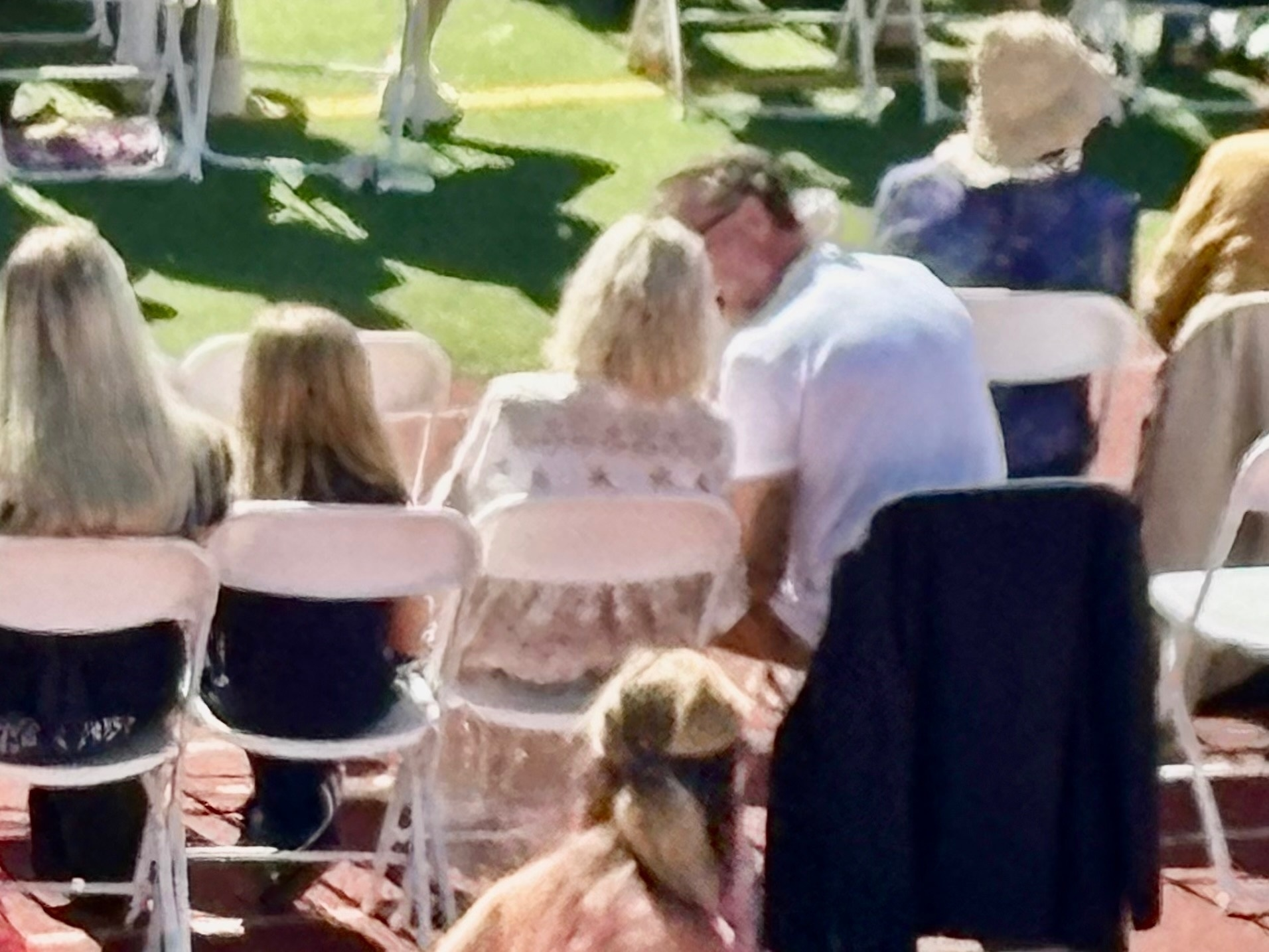 Tori Spelling and Dean McDermott chatting at their daughter's graduation.