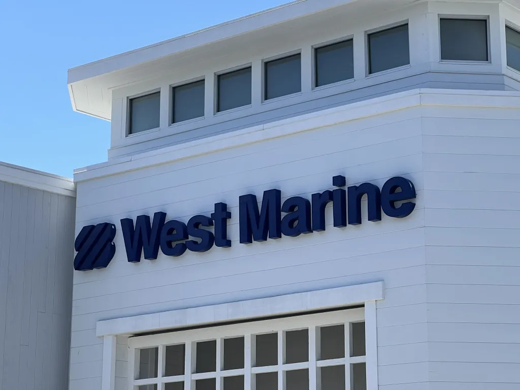 Exterior view of the West Marine store with branded signage on a clear day in Newport Beach, California.