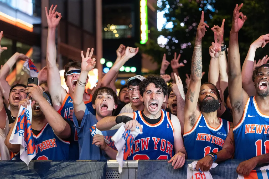 New York Knicks fans cheer outside Madison Square Garden during Game 5 of the NBA Finals.