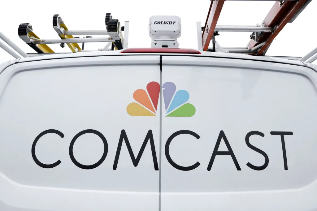 The back of a white Comcast service truck with the company logo.