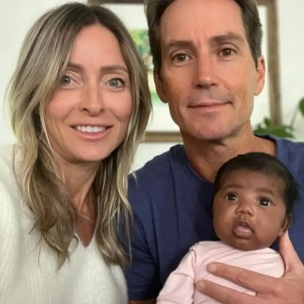 A Florida couple holding an infant.