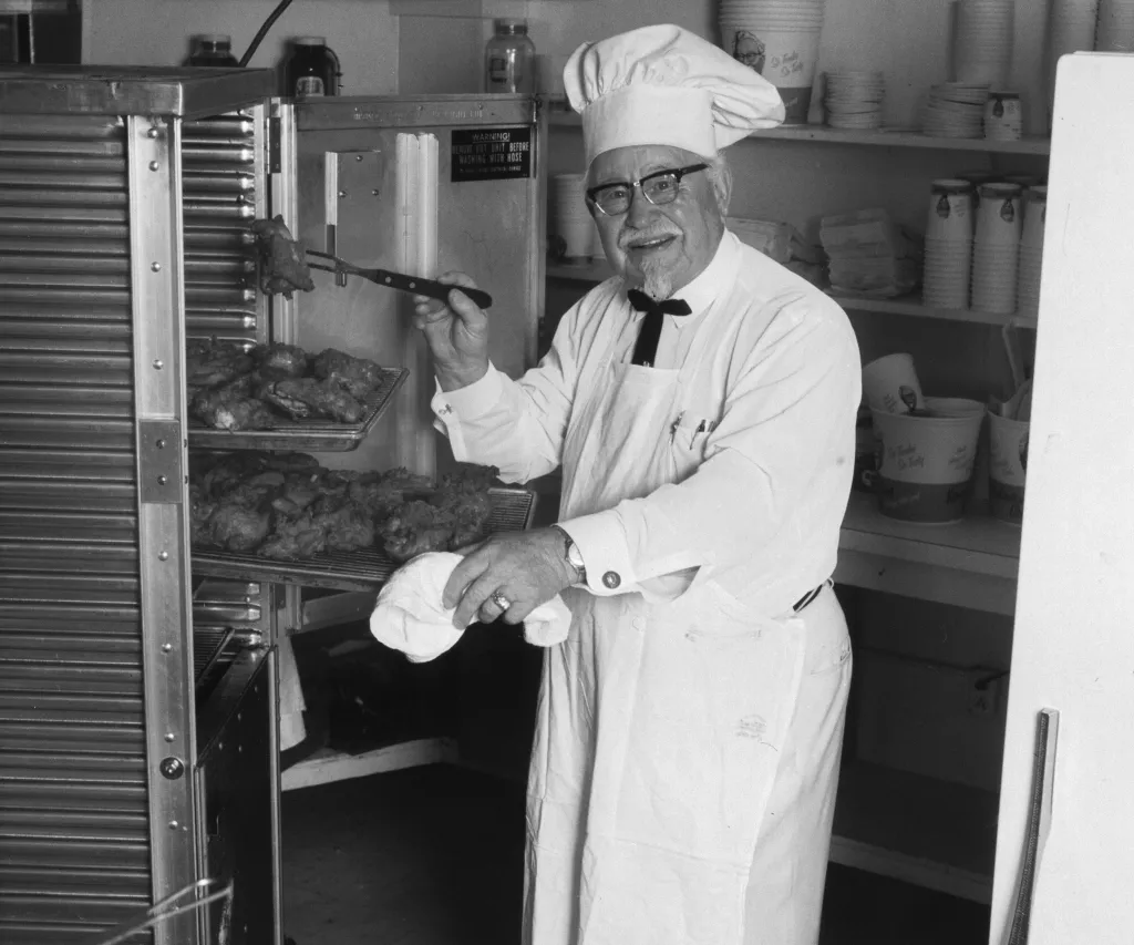 Colonel Sanders cooking fried chicken.