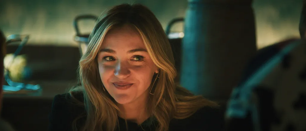 Natalie 'Sugar' Berzatto with a slight smirk.