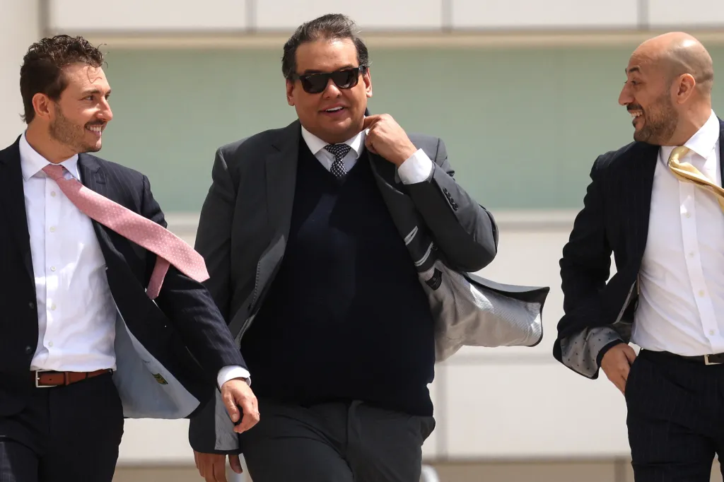 George Santos departs federal courthouse with two men.