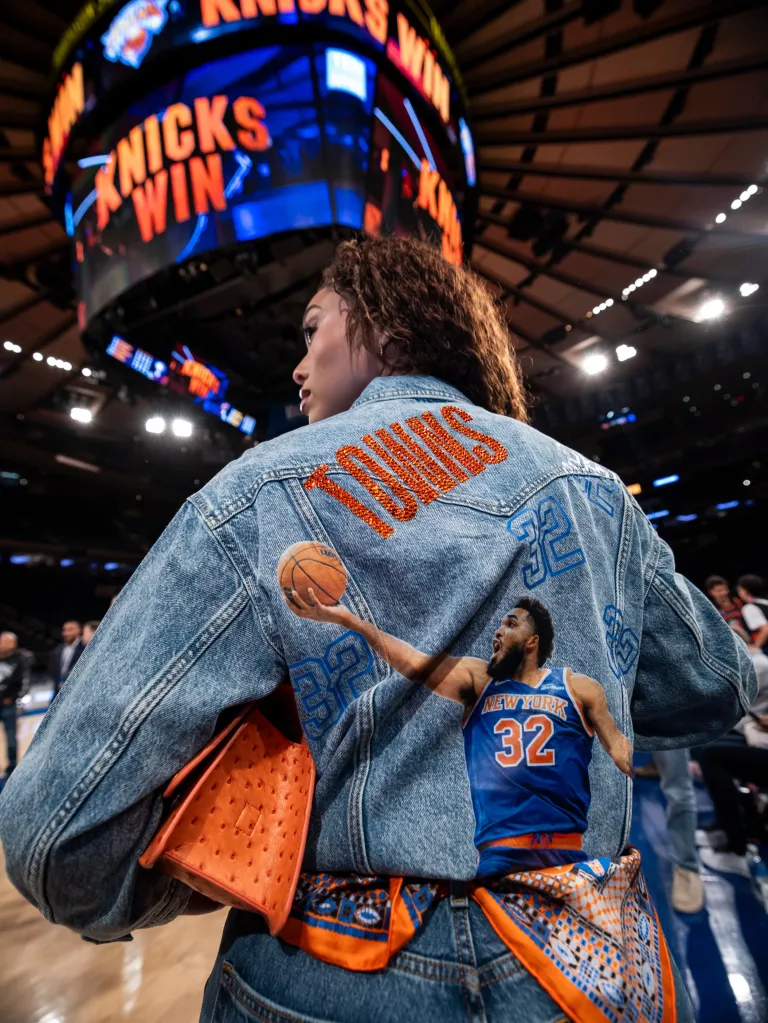 Jordyn Woods at a Knicks game, wearing a denim jacket with 