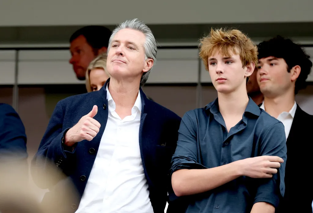 California Governor Gavin Newsom and a young man watching the FIFA World Cup 2026 match.