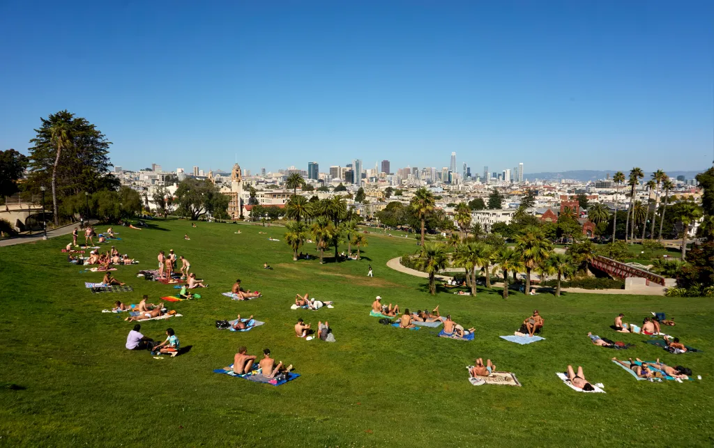 A group of people sunbathe in Dolores Park in San Francisco.