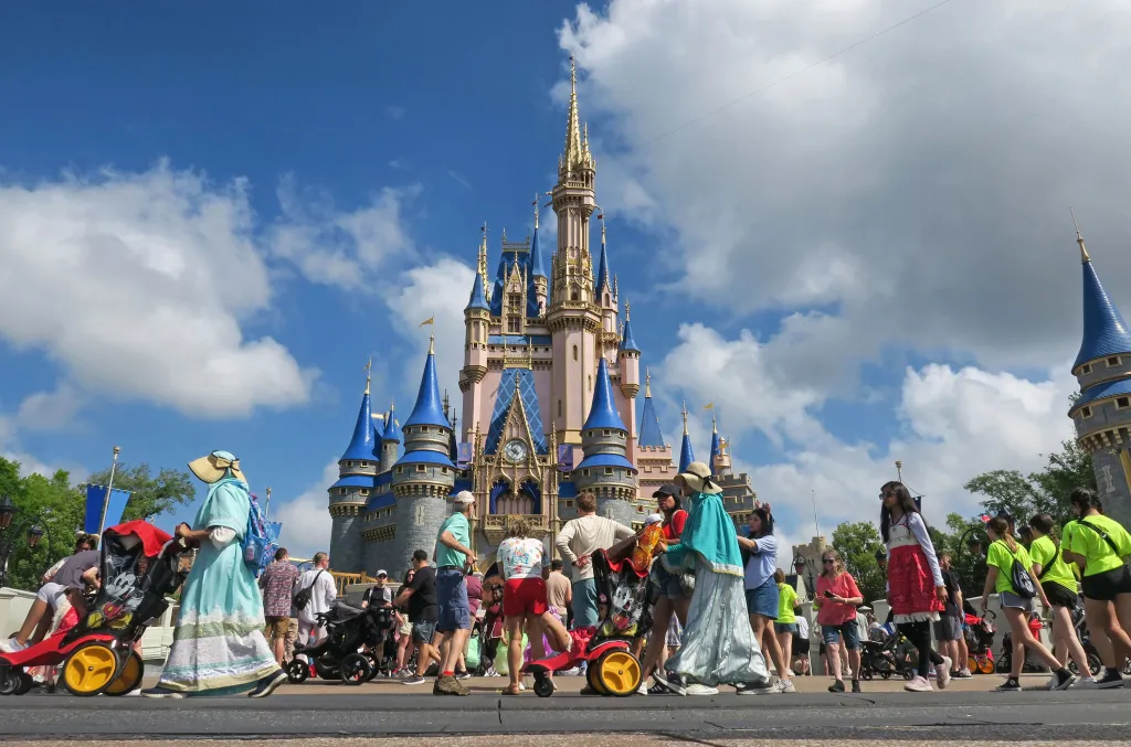 Guests walk past Cinderella Castle at Magic Kingdom in Walt Disney World.