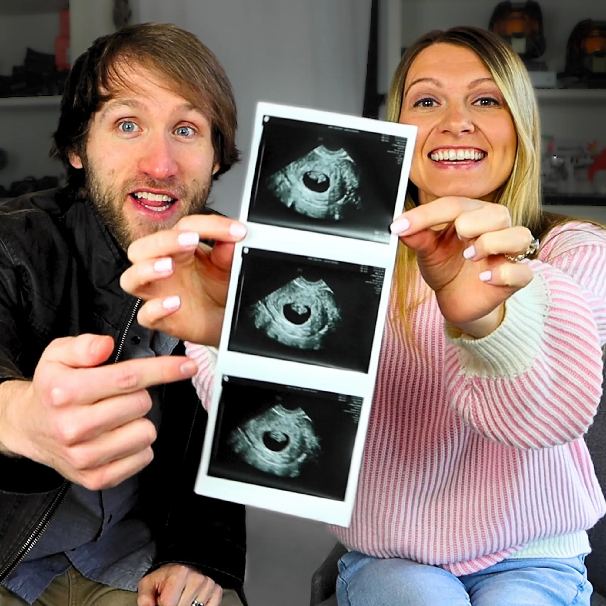 Jesse Ridgway and his wife smiling and holding up a strip of three ultrasound images.