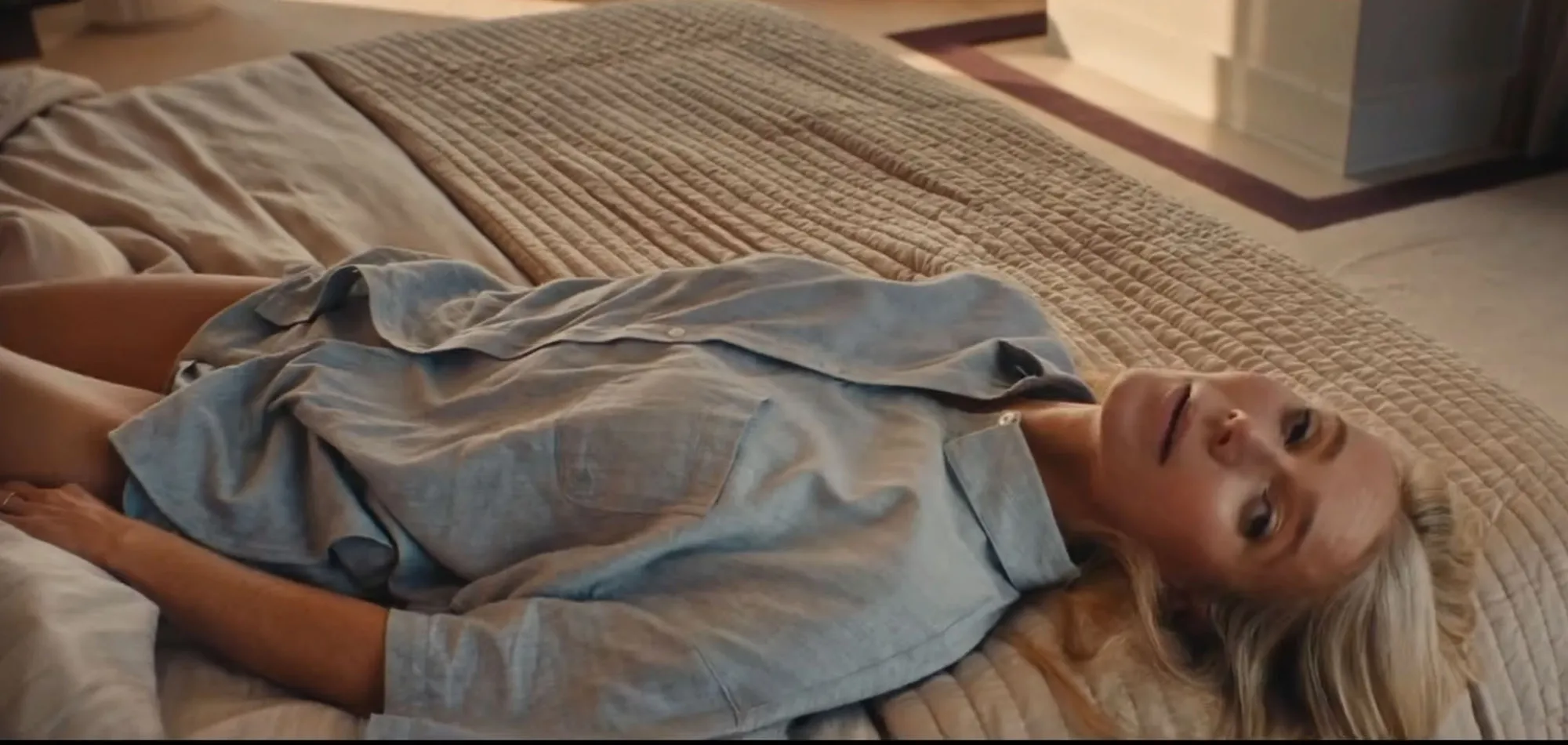 Gwyneth Paltrow lying on a bed in a 51 Park ad.