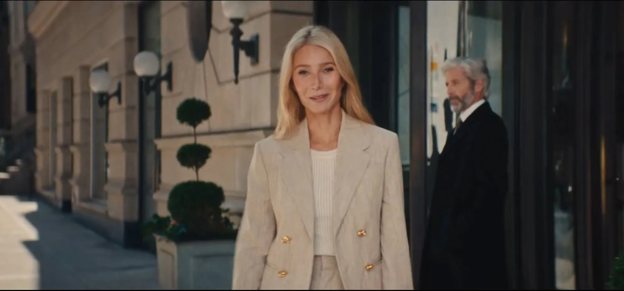 Gwyneth Paltrow in a light blazer outside a building.