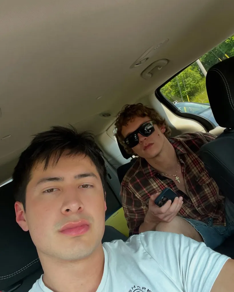 Hudson Williams and Connor Storrie in a car.