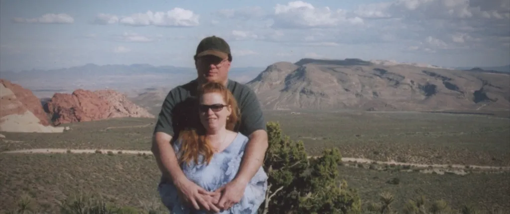 Rex Heuermann with Asa Ellerup in front of a mountainous desert landscape.