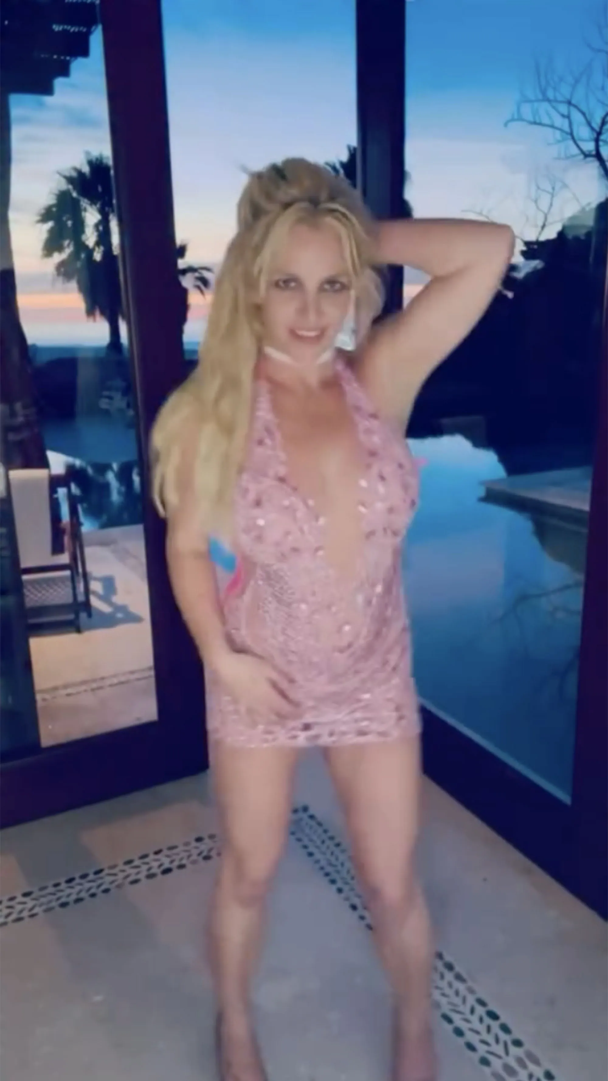 Britney Spears in a sparkly pink dress with a plunging neckline.