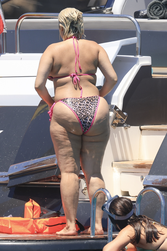 Bebe Rexha in an animal print bikini on a boat in Ibiza.