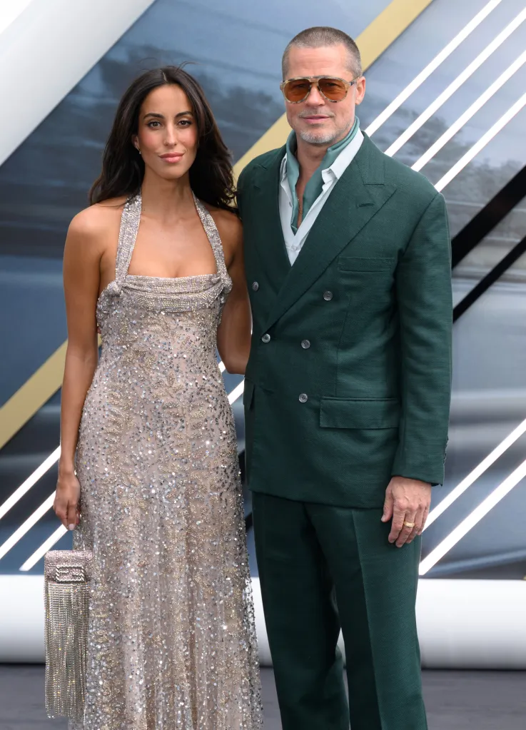 Ines de Ramon in a sparkly gown and Brad Pitt in a green suit and sunglasses at a movie premiere.