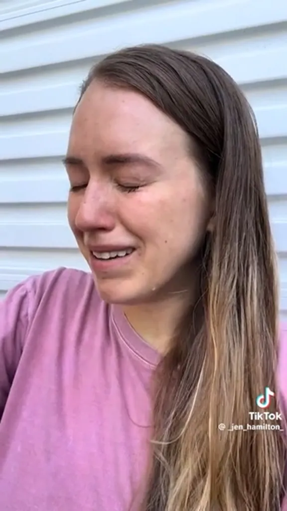 Jen Hamilton crying in a pink shirt.