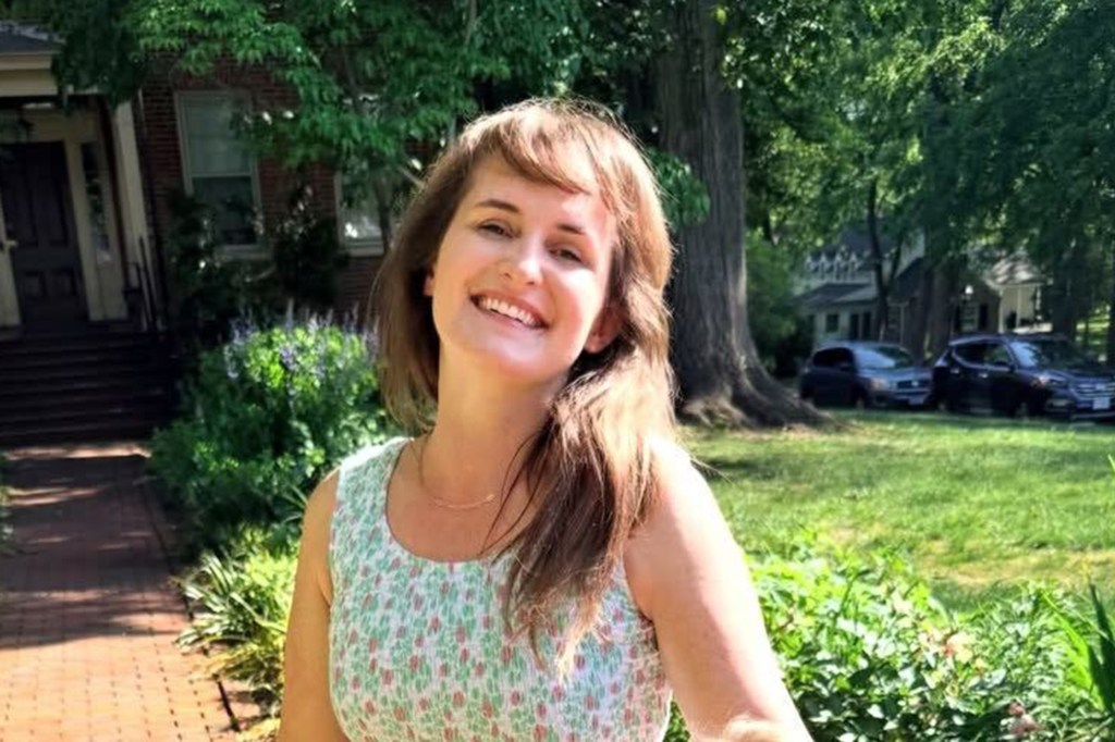 Lyndsey Fifield smiling outdoors in a floral dress.