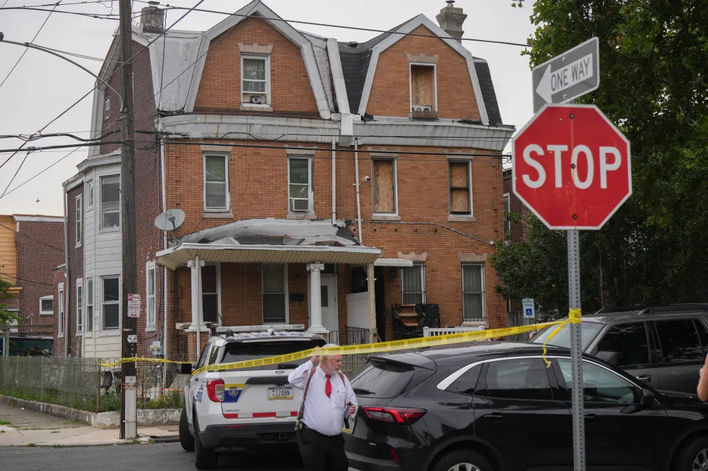 Investigators search a home in the Olney section of Philadelphia.