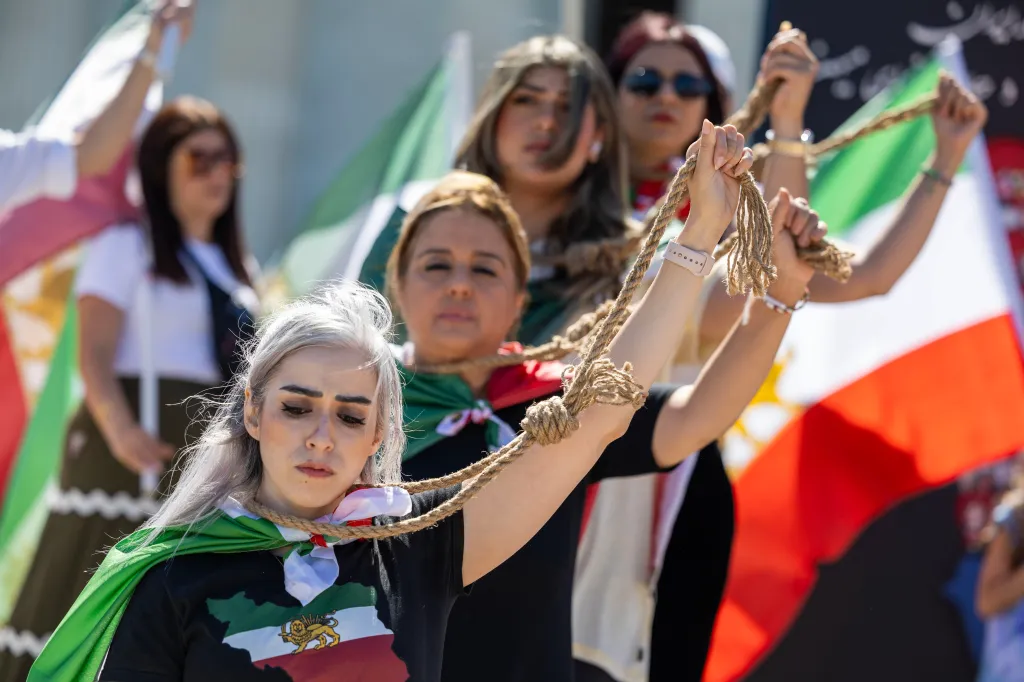 Women protesting Iranian government executions with ropes around their necks.
