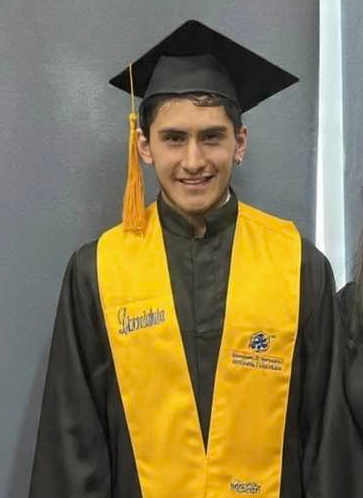 Irving Mauricio in a graduation cap and gown.