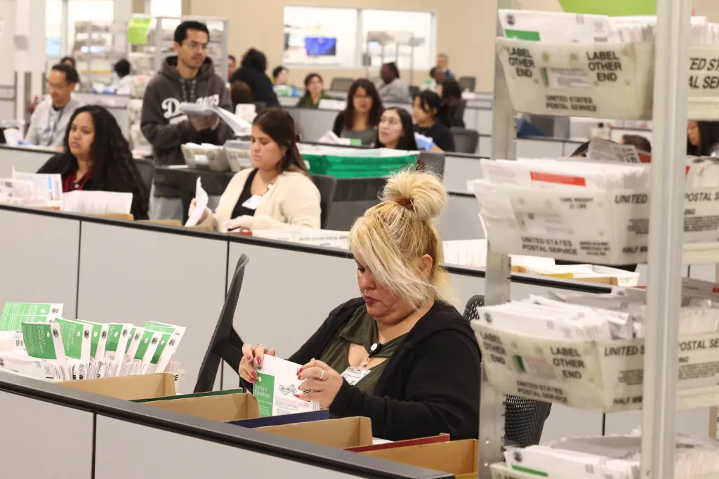 Election workers processing ballots at a Los Angeles County facility.