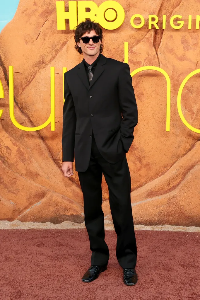 Jacob Elordi wearing a black suit and black sunglasses at the premiere of