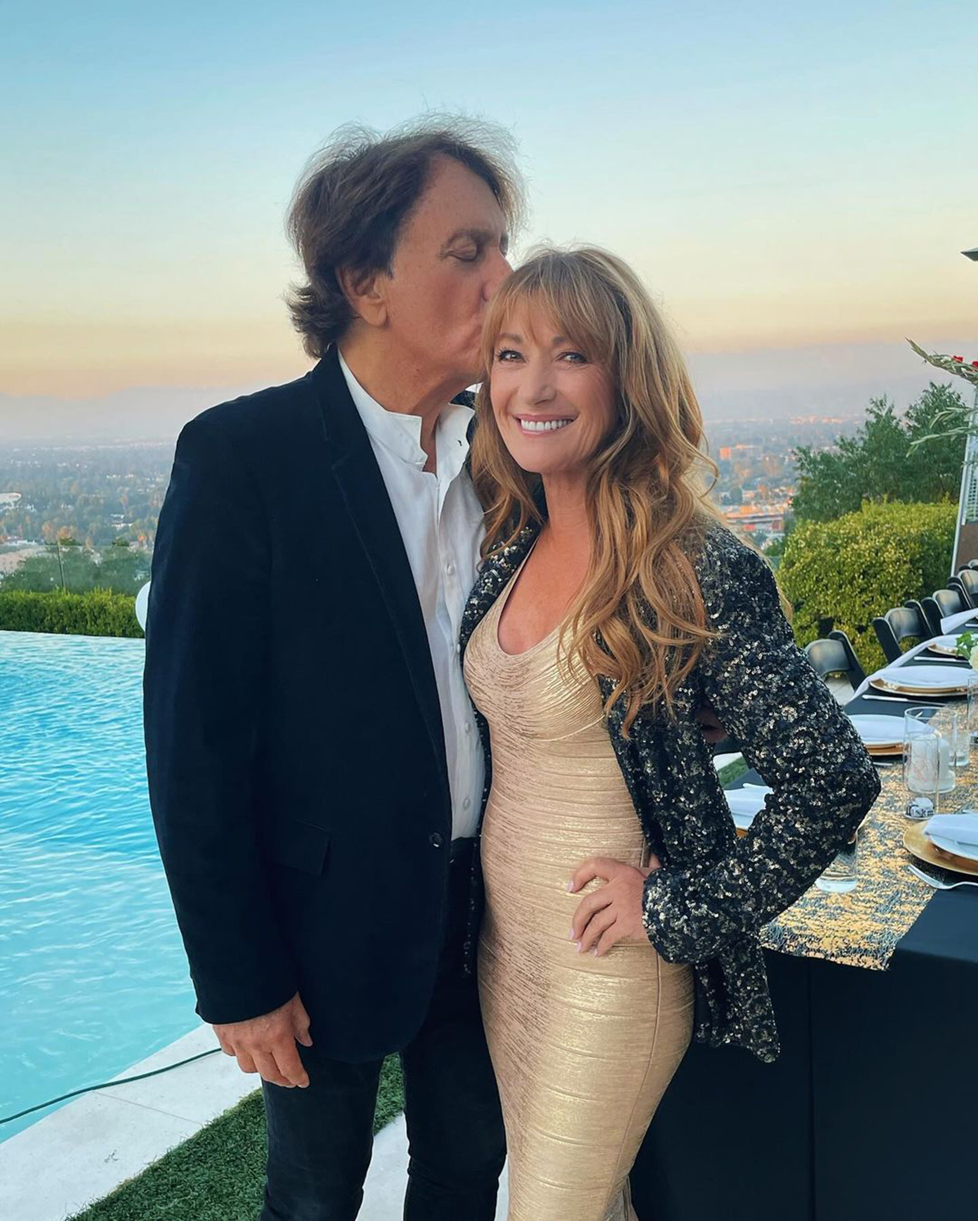 Jane Seymour and John Zambetti posing for a photo, with Zambetti kissing Seymour on the forehead.