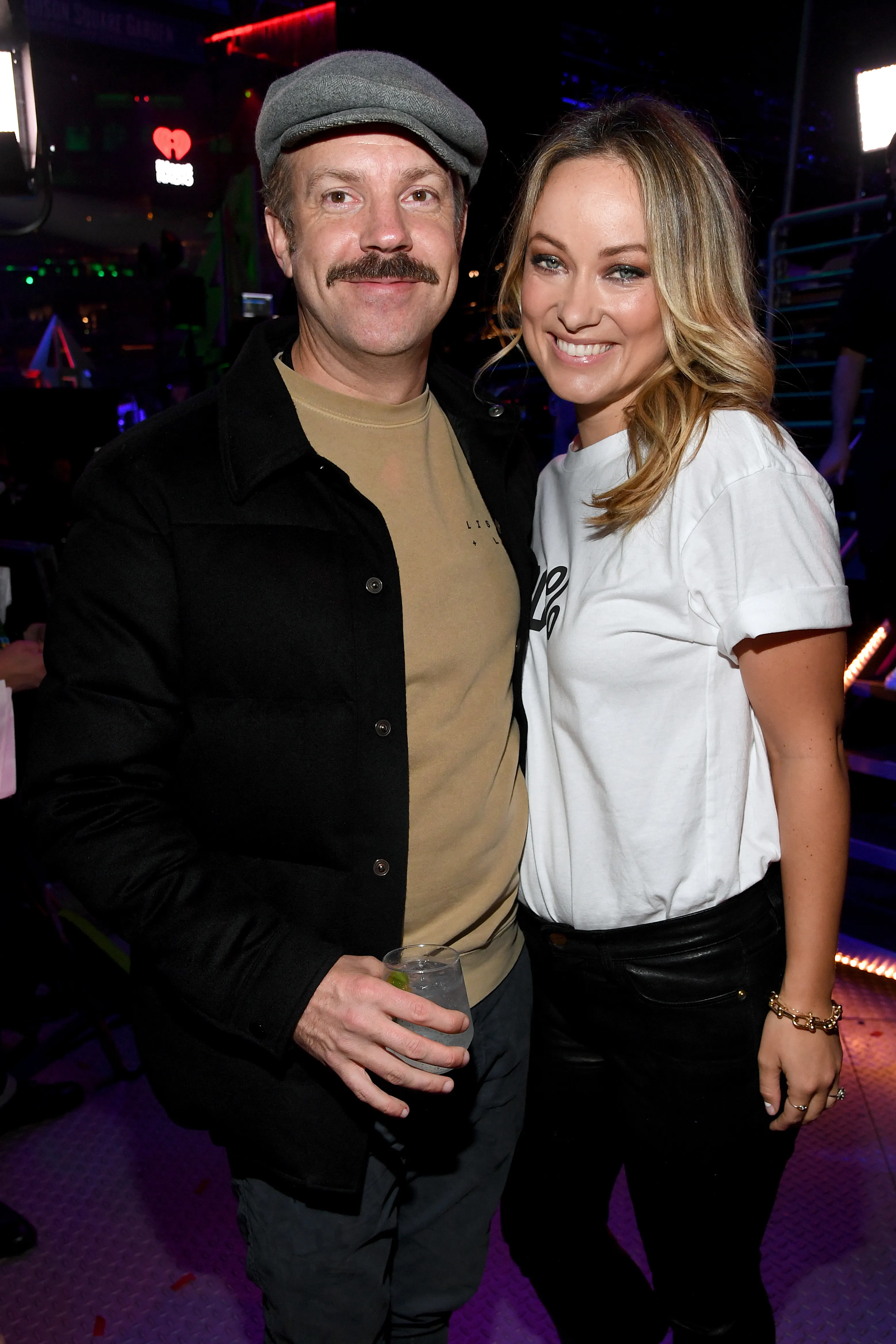 Jason Sudeikis and Olivia Wilde posing backstage at the iHeartRadio Z100 Jingle Ball 2019.