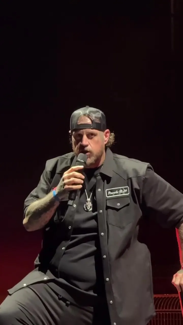 Jelly Roll performing on stage, speaking into a microphone.