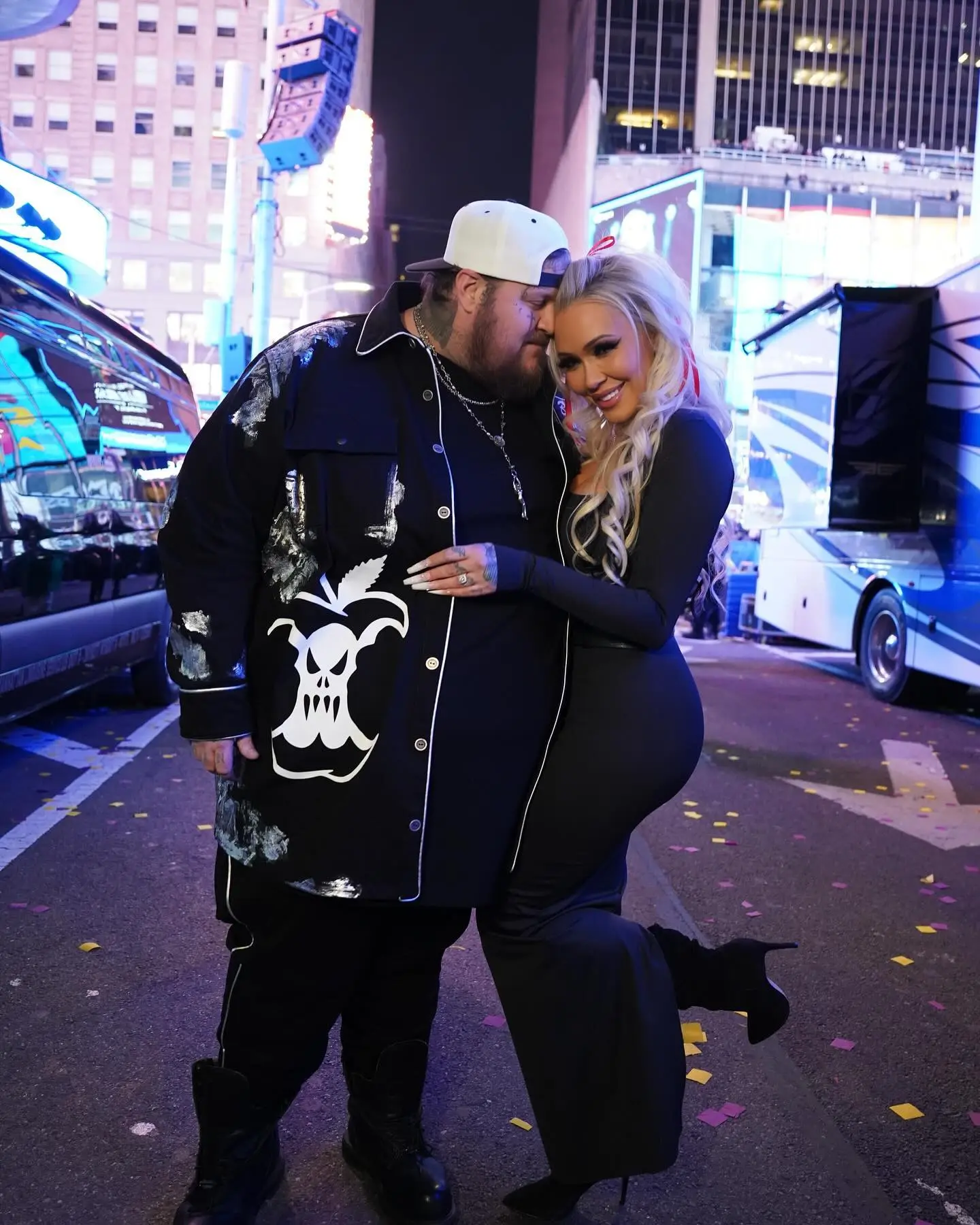 Jelly Roll and Bunnie XO posing together on a city street.