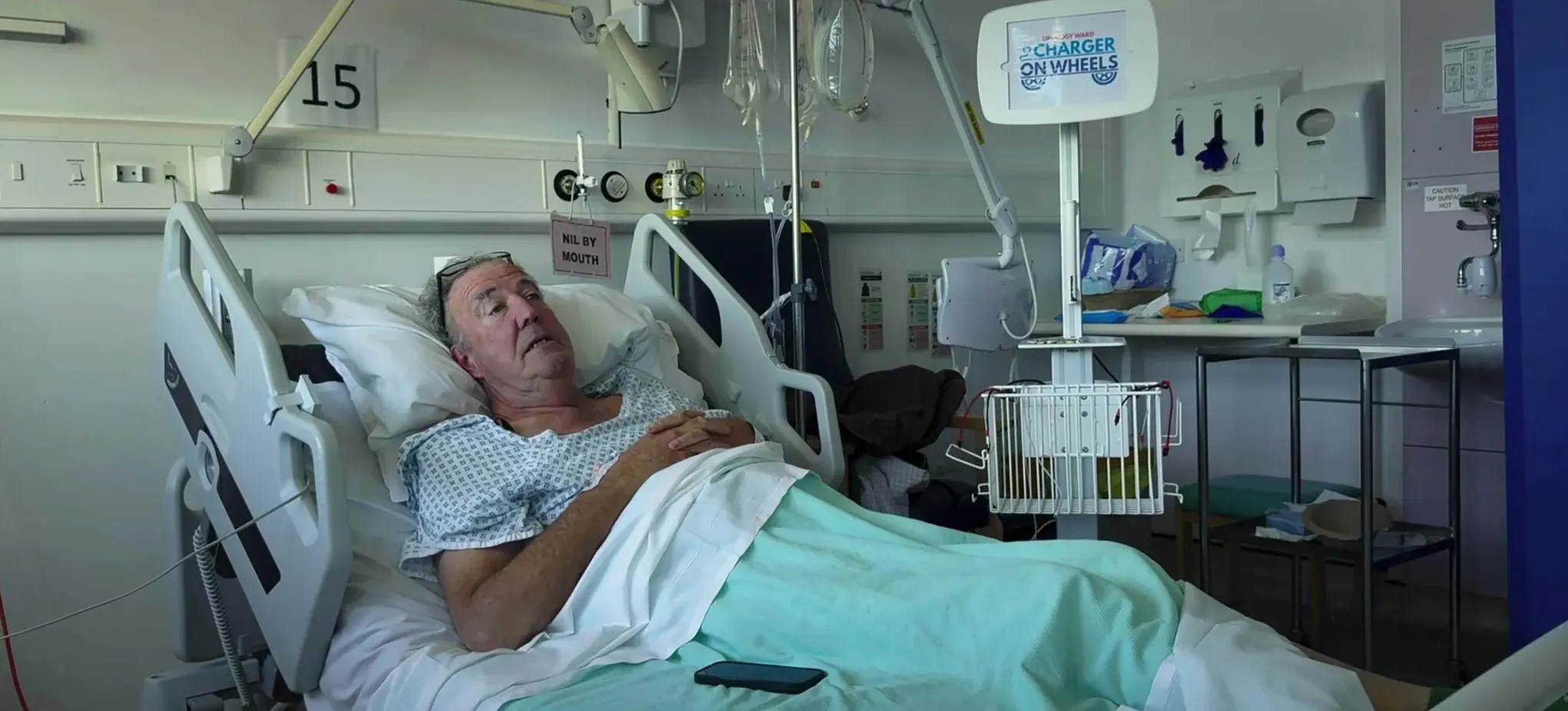 Jeremy Clarkson in a hospital bed with an IV drip.