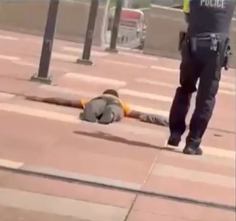 John Elijah Matthews lays on the ground as police detain him after the brutal stabbing on May 30, 2026.