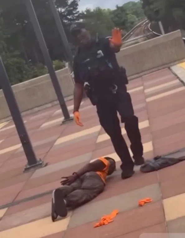 John Elijah Matthews, 25, is detained by police after stabbing and killing Margaret Swan, 66, on a Metropolitan Atlanta Rapid Transit Authority's (MARTA) approaching Oakland City in Atlanta, Georgia.