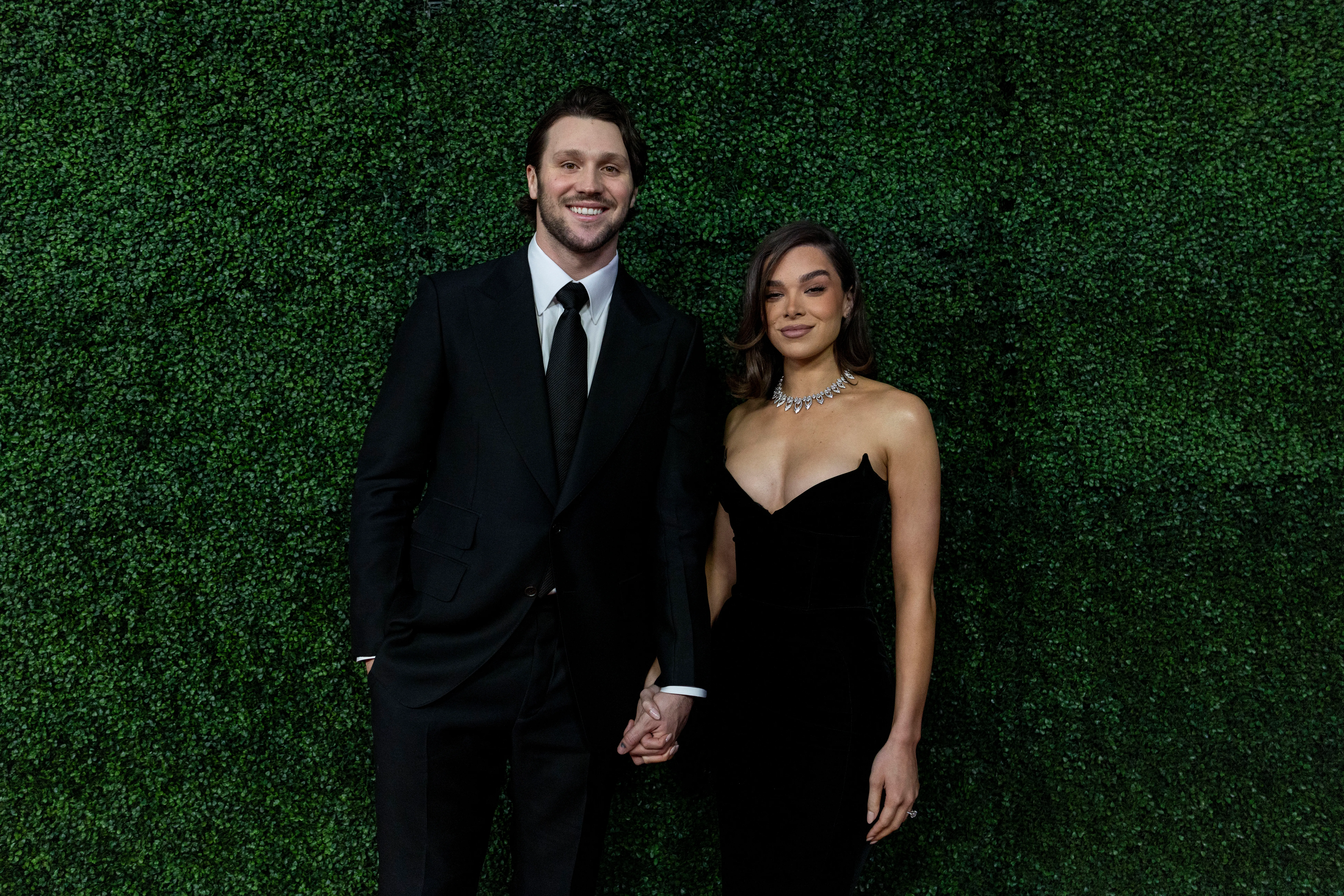 Josh Allen and Hailee Steinfeld pose for a photo on a red carpet.