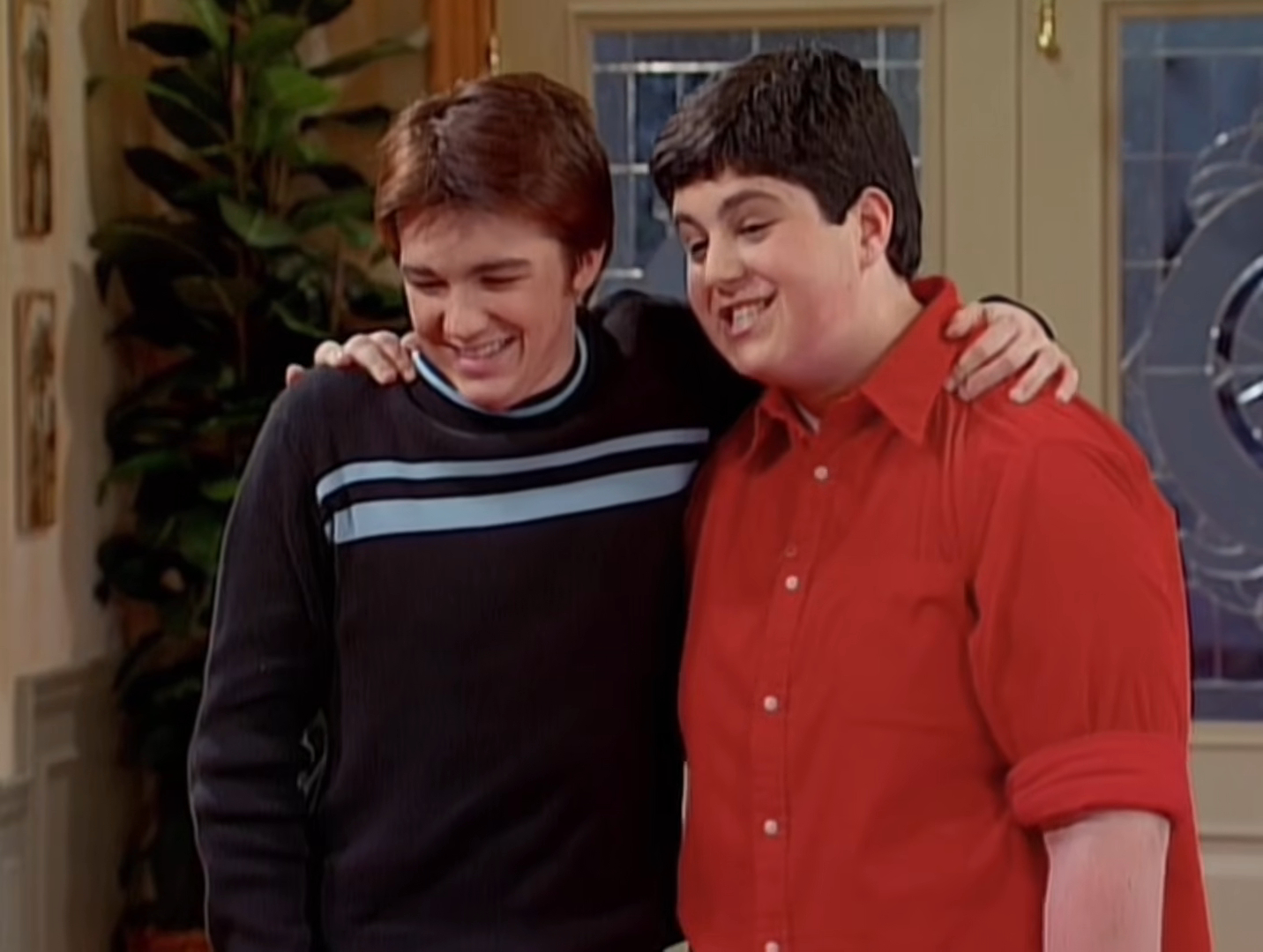 Josh Peck and Drake Bell laughing in an embrace from Drake & Josh.