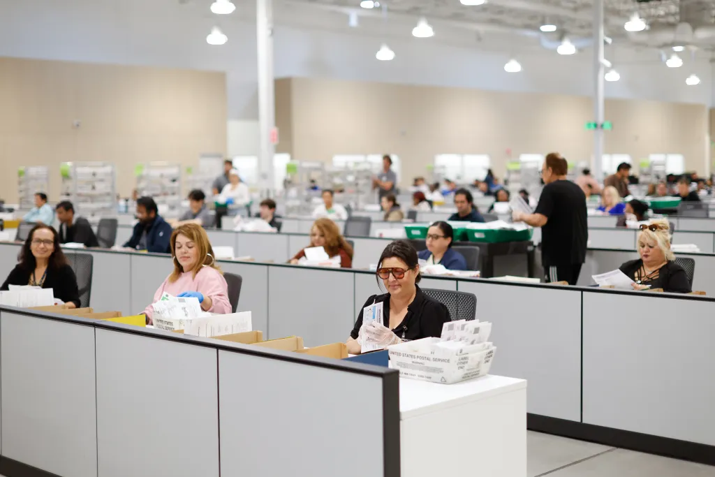 People counting ballots at the LA County Election Center.