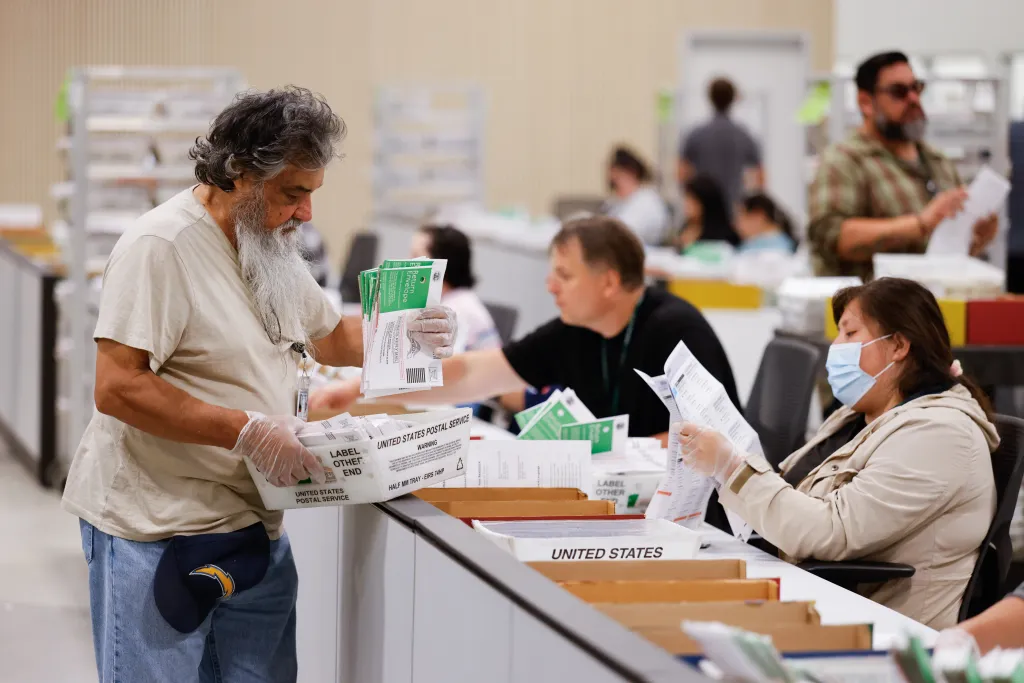 People counting ballots at the LA County Election Center.