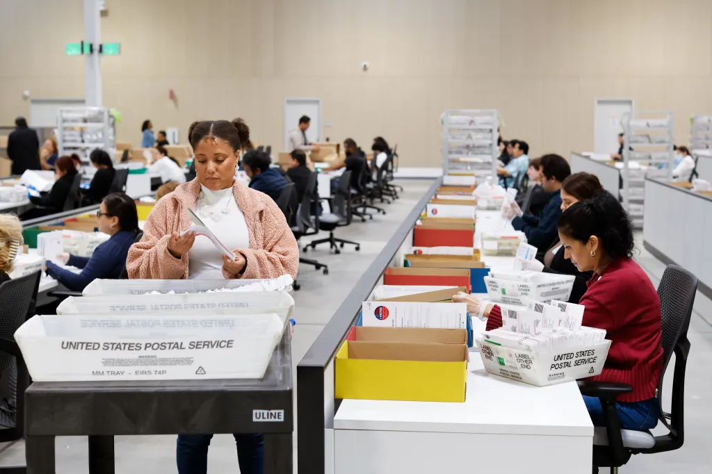 People sorting ballots at the LA County Election Center.