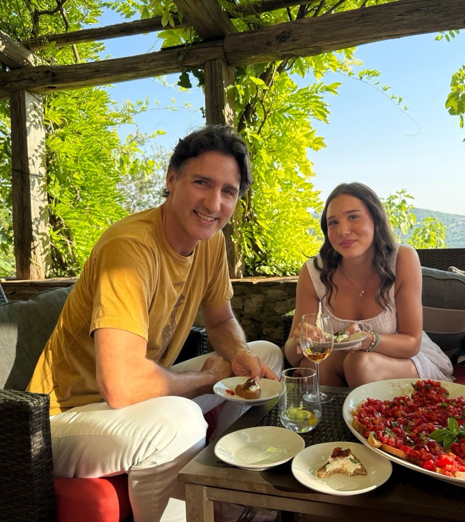 Justin Trudeau and his daughter Ella Grace smiling at a table with bruschetta.