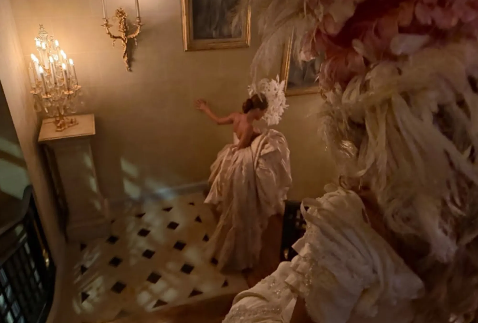Bianca Censori in a white dress at a masquerade-themed birthday party.