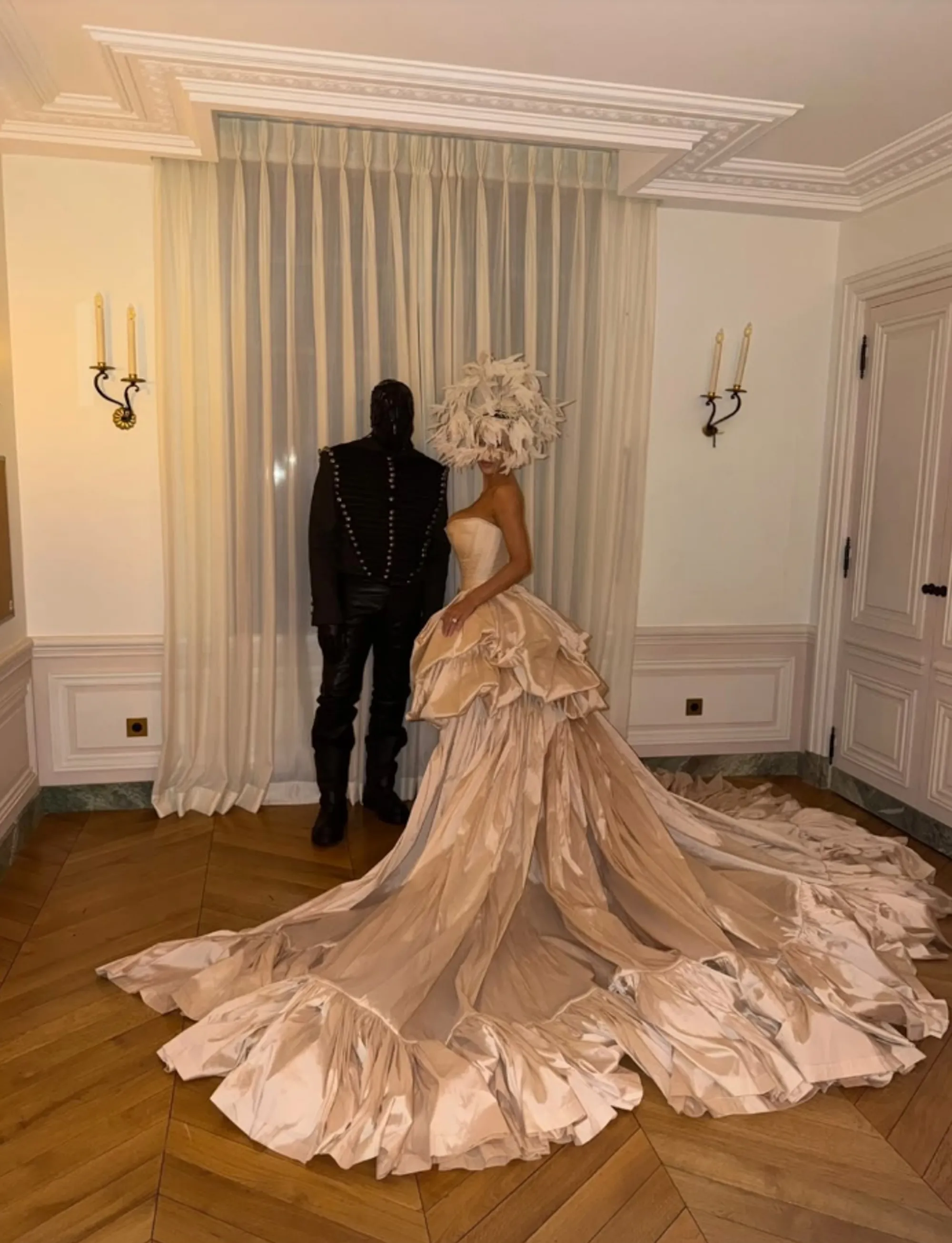 Kanye West and Bianca Censori in masquerade-themed attire.