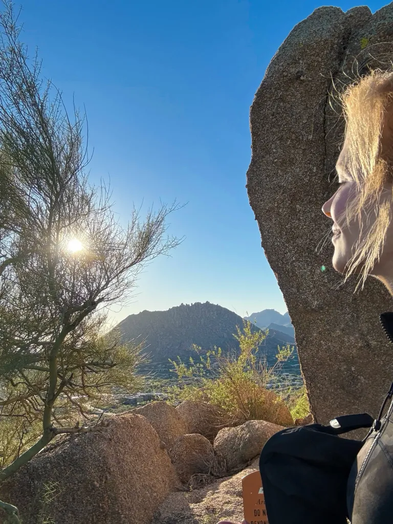 Nicole Kidman looking at a mountain range at sunset.