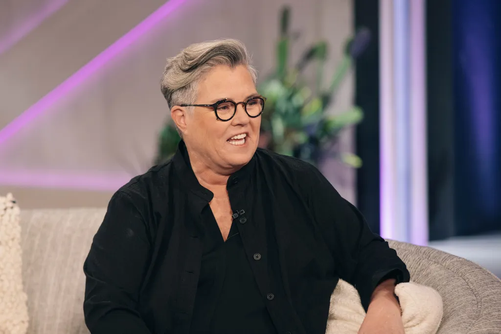 Rosie O'Donnell seated on a talk show.