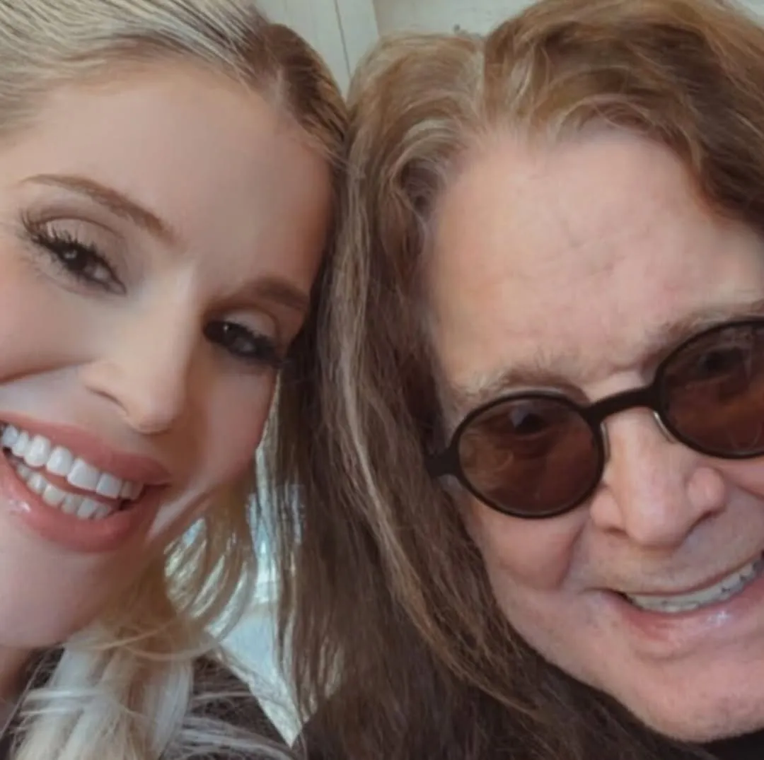 Kelly Osbourne and Ozzy Osbourne smiling together.