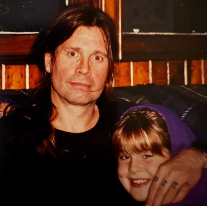 Ozzy Osbourne with his arm around a young Kelly Osbourne.